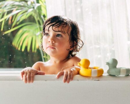 Non-Professional plays in baths with a toy