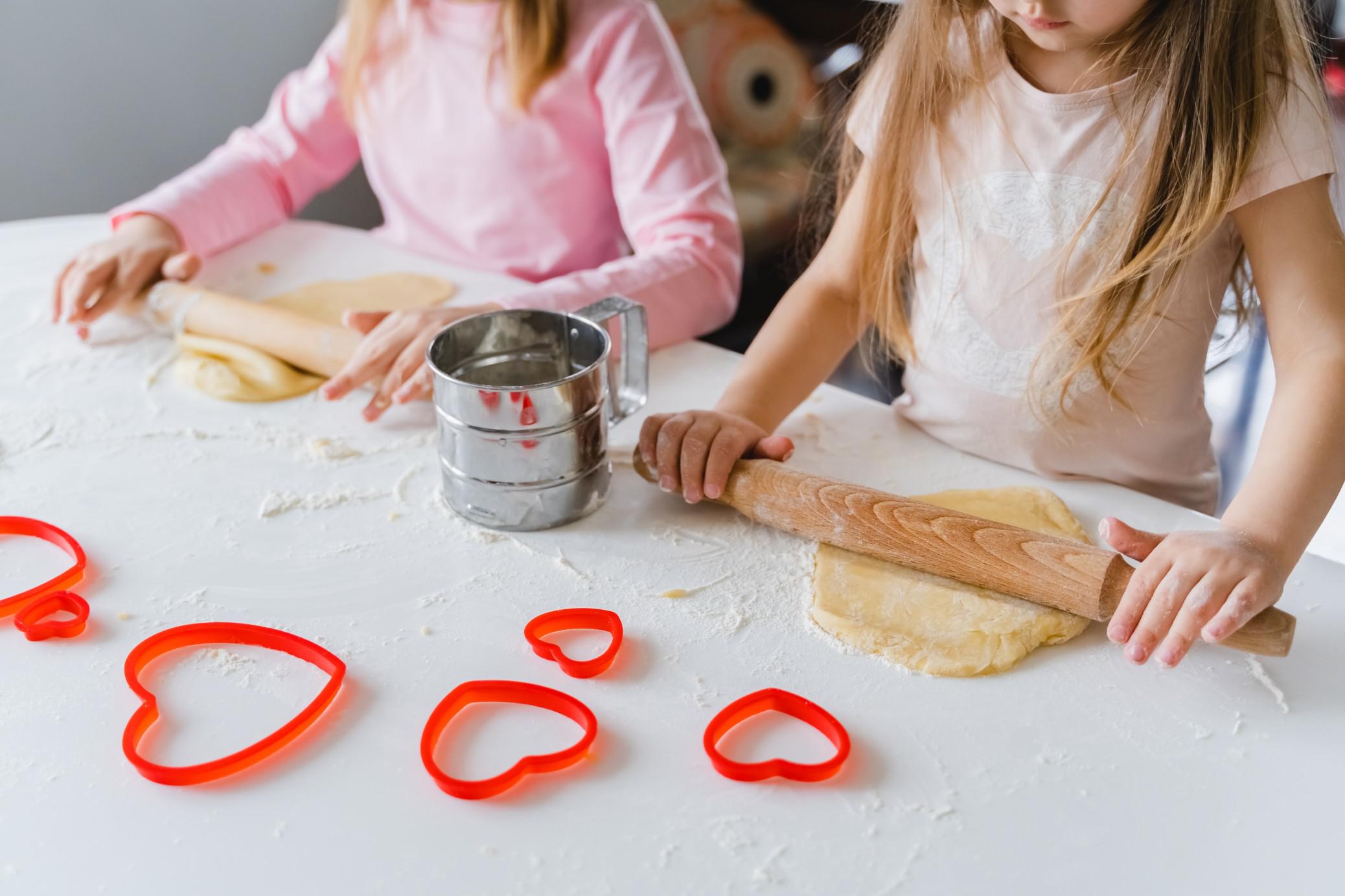 kids rolling out cookie dough- valentine's day snacks