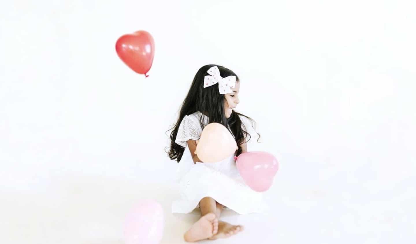 little girl with heart balloons-valentine's gifts for kids