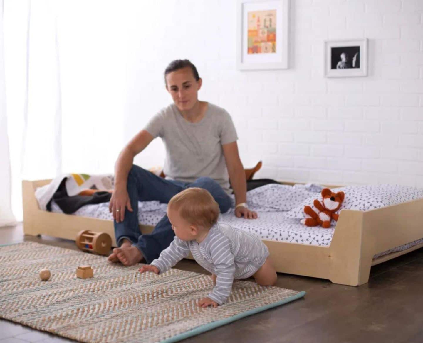 baby crawling on floor next to Montessori furniture