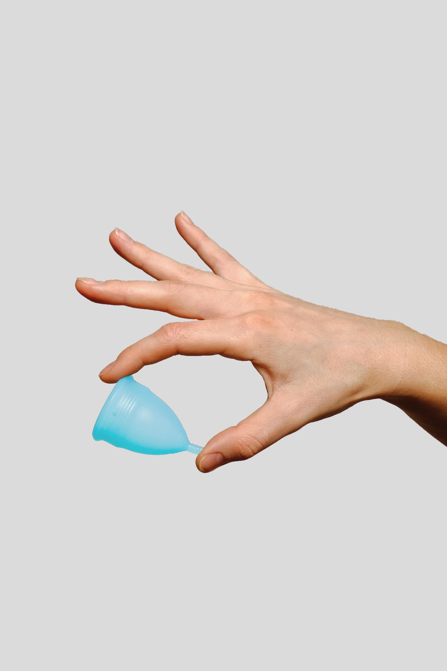 hand holding a menstrual cup