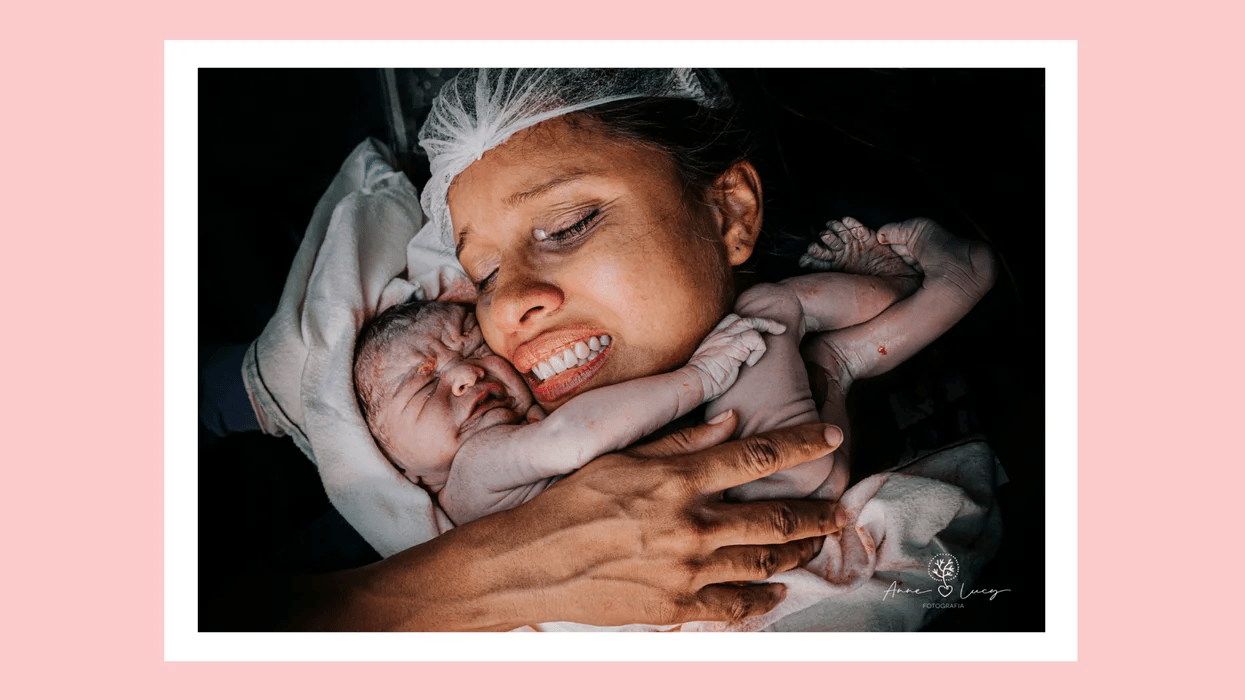 mom holding newborn baby on her chest at hospital after birth