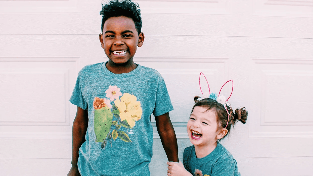 siblings wearing easter shirts and bunny ears