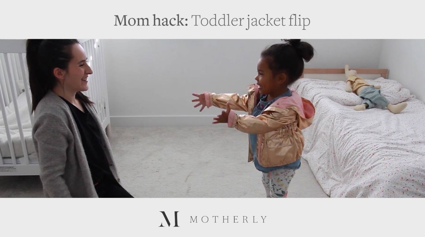 toddler putting on a jacket