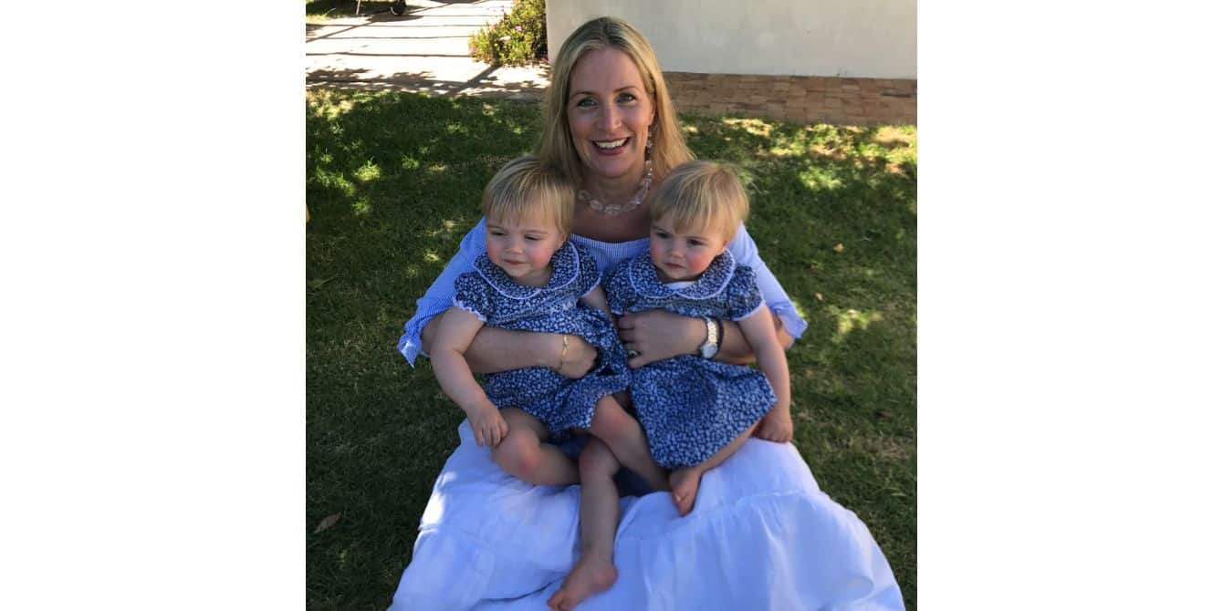 women holding her two children on her lap - essay on experiencing postpartum depression