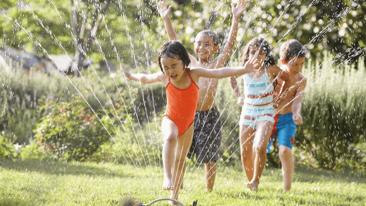 kids playing in a sprinkler