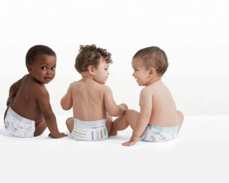 three babies wearing diapers in photography studio Motherly