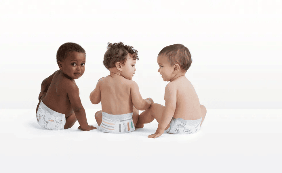 three babies wearing natural diapers in photography studio