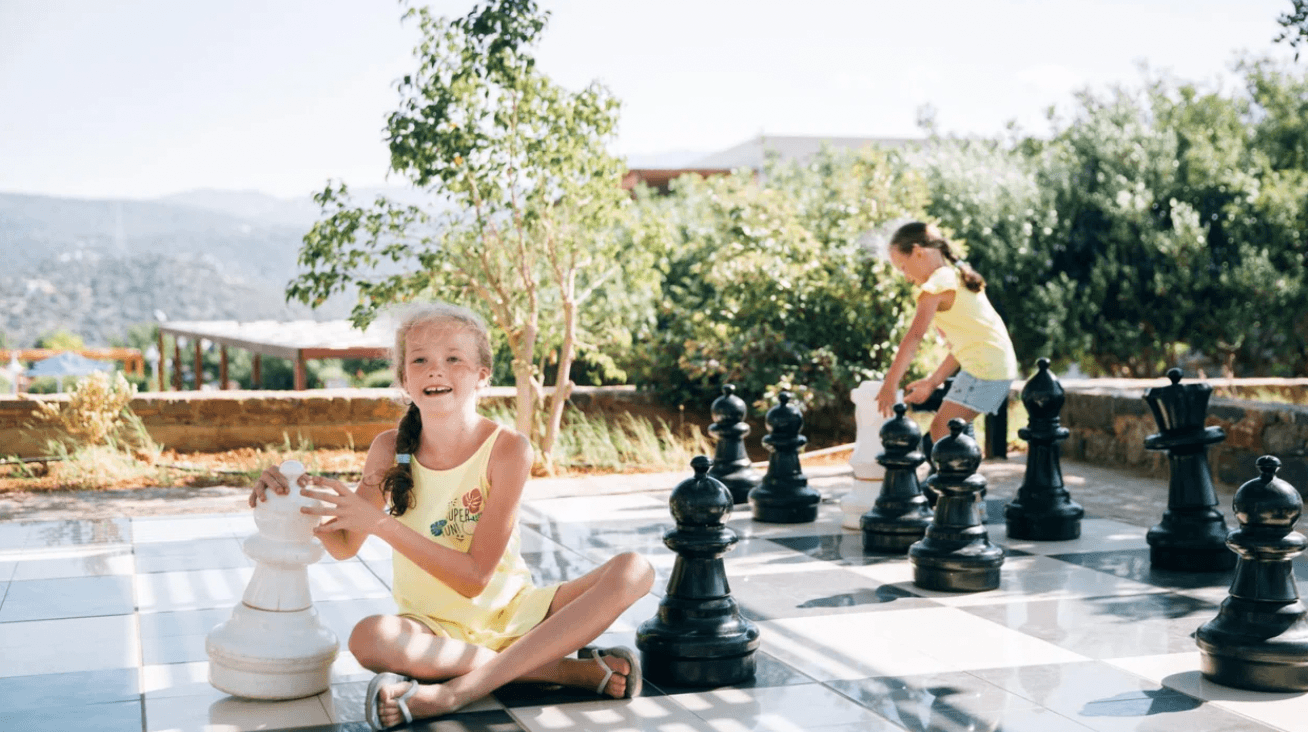 siblings playing with outdoor lawn games- giant yard games