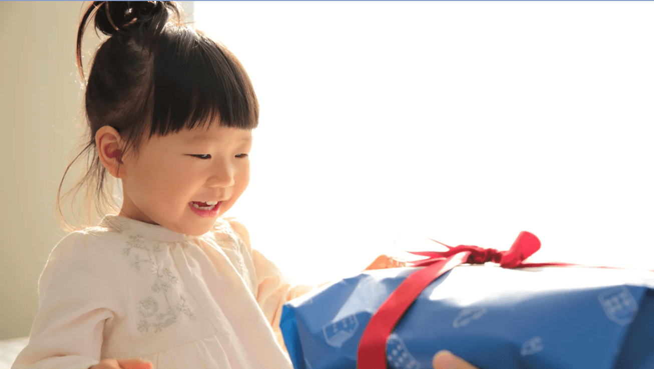 little girl opening gift