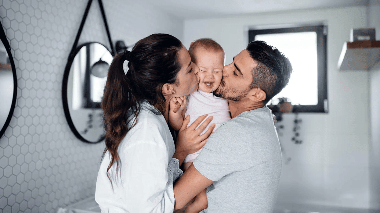 portrait of young couple with toddler girl Motherly