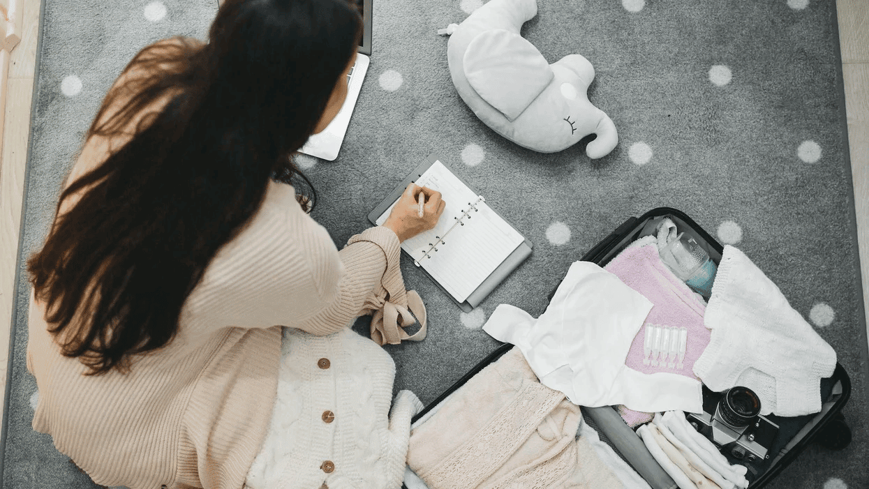 pregnant mom packing hospital bag for baby