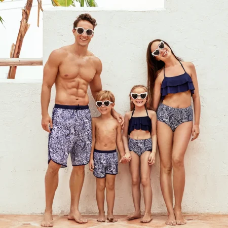 family wearing matching navy blue swimsuits