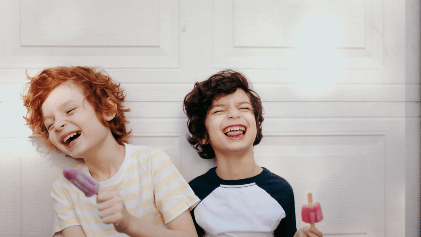 little boys eating popsicles