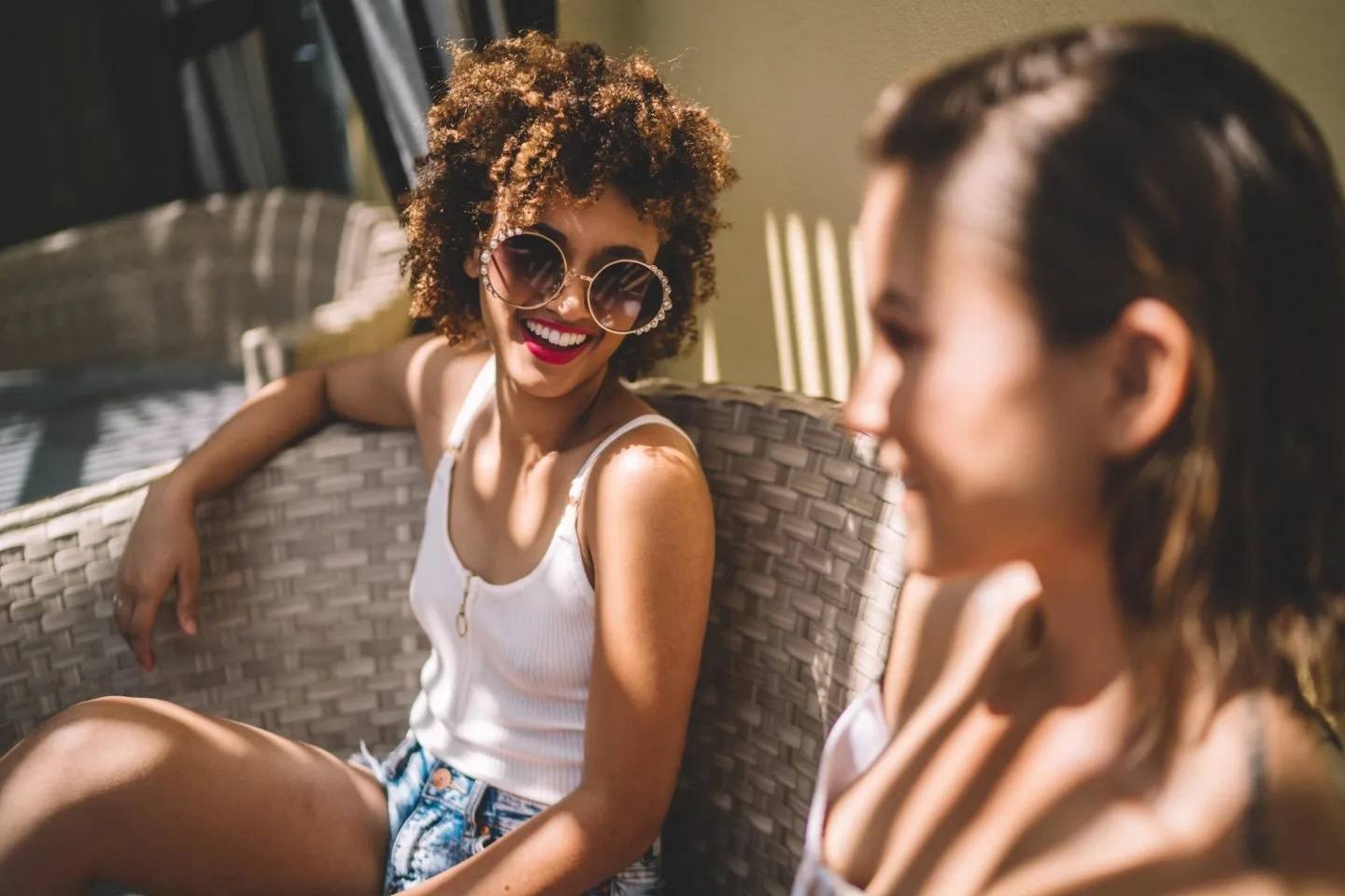 two women sitting outside talking