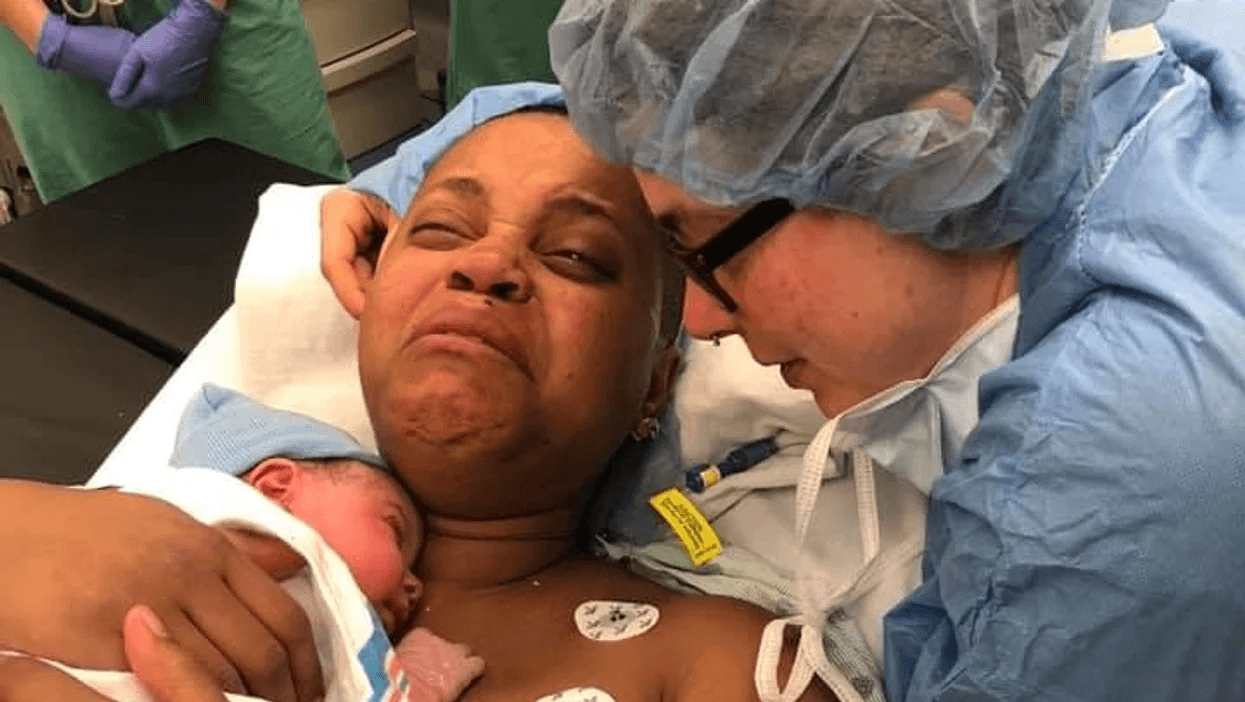 woman crying with her newborn baby on her chest