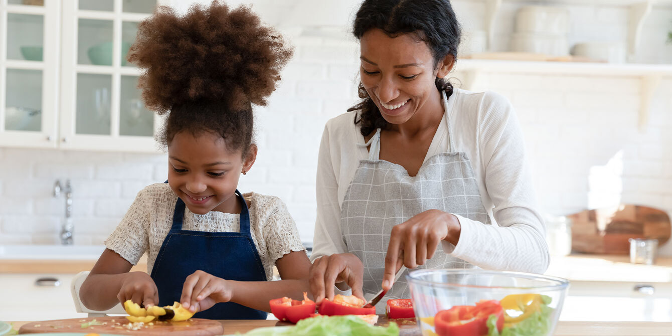 mom and daughter chopping vegetables in the kitchen-iron rich food for vegetarian