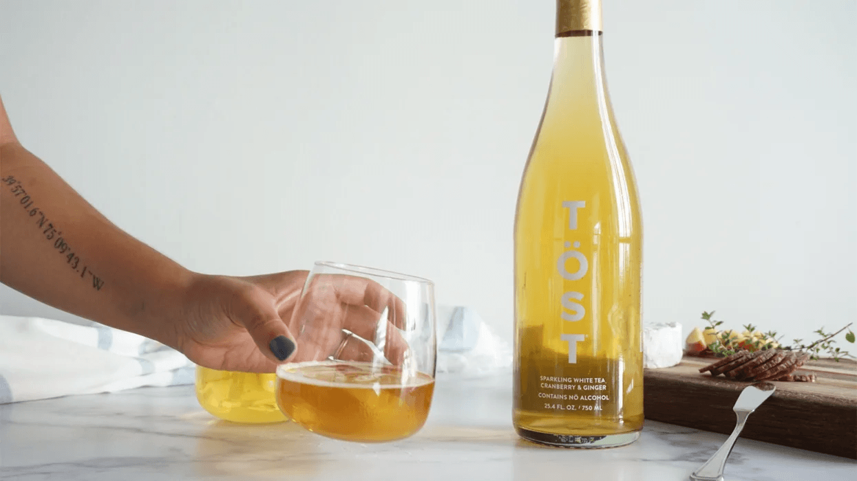 woman drinking a glass of TOST