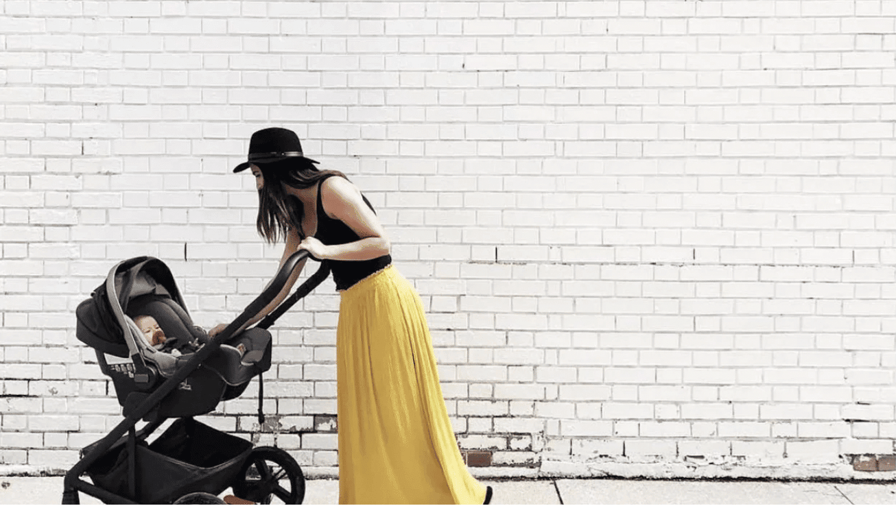 mom comforting a baby in a stroller