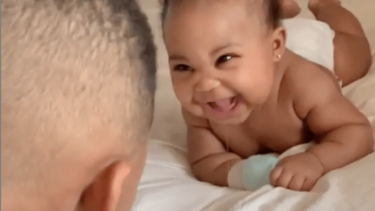 baby girl laughing at mom