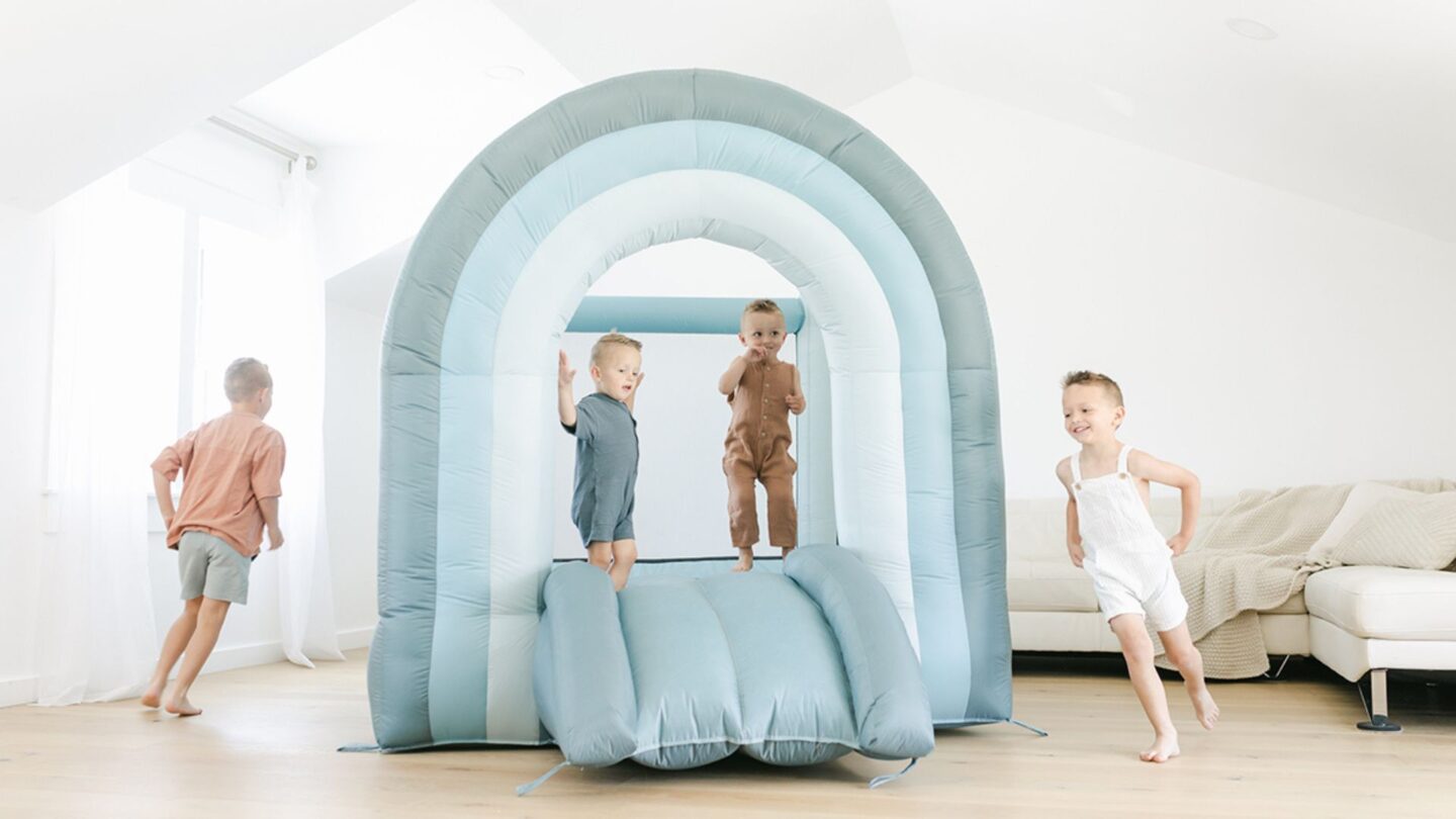 three kids playing on an indoor bounce house - Best toys for active toddlers