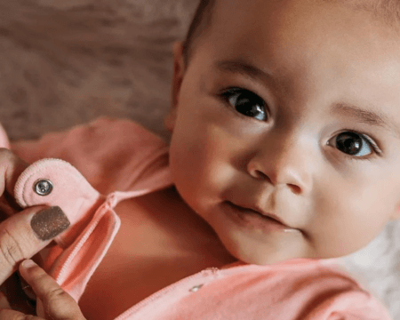 baby looking at the camera in organic baby clothes