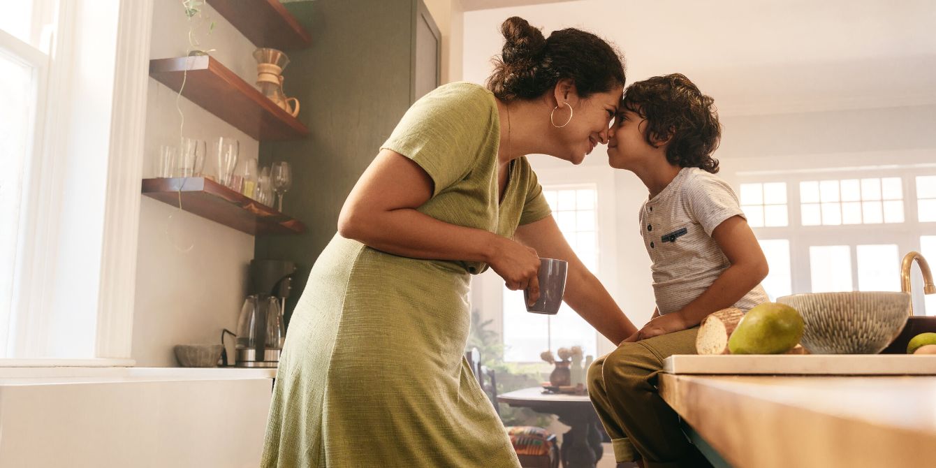 mother touching noses with son in kitchen - raise resilient kids