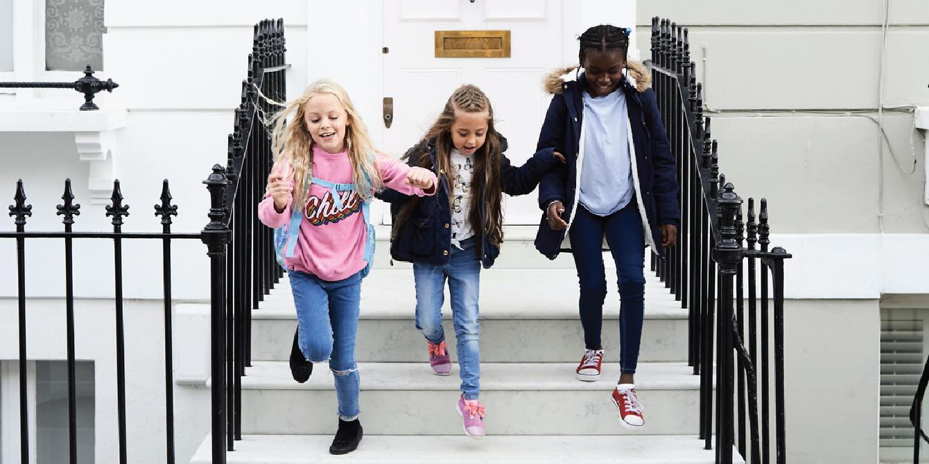 kids running down school stairs - raising girls