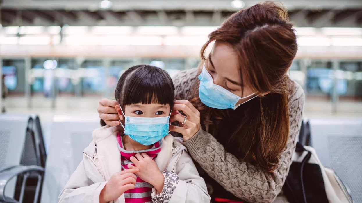 woman-traveling-with-child-wearing-masks