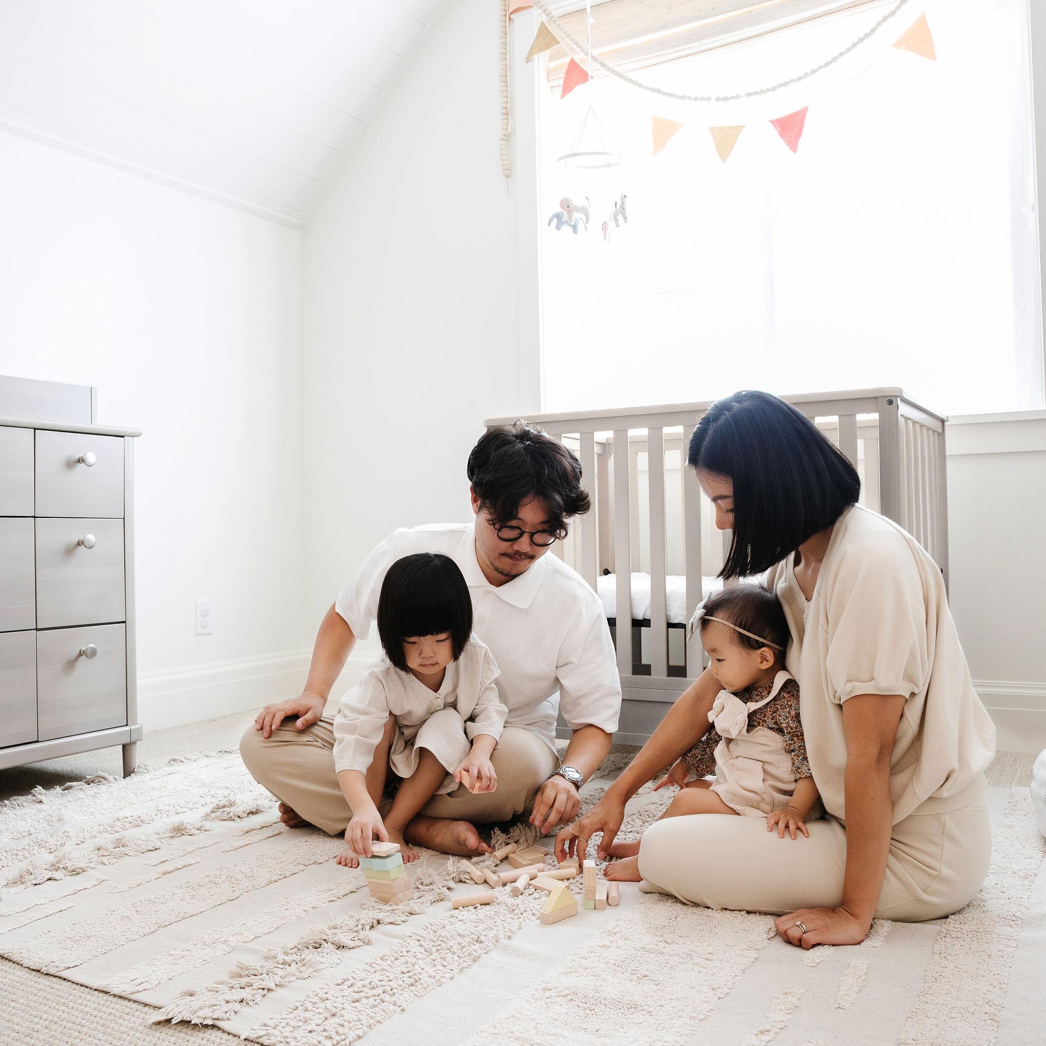 family-playing-together-on-the-floor-of-a-nursery