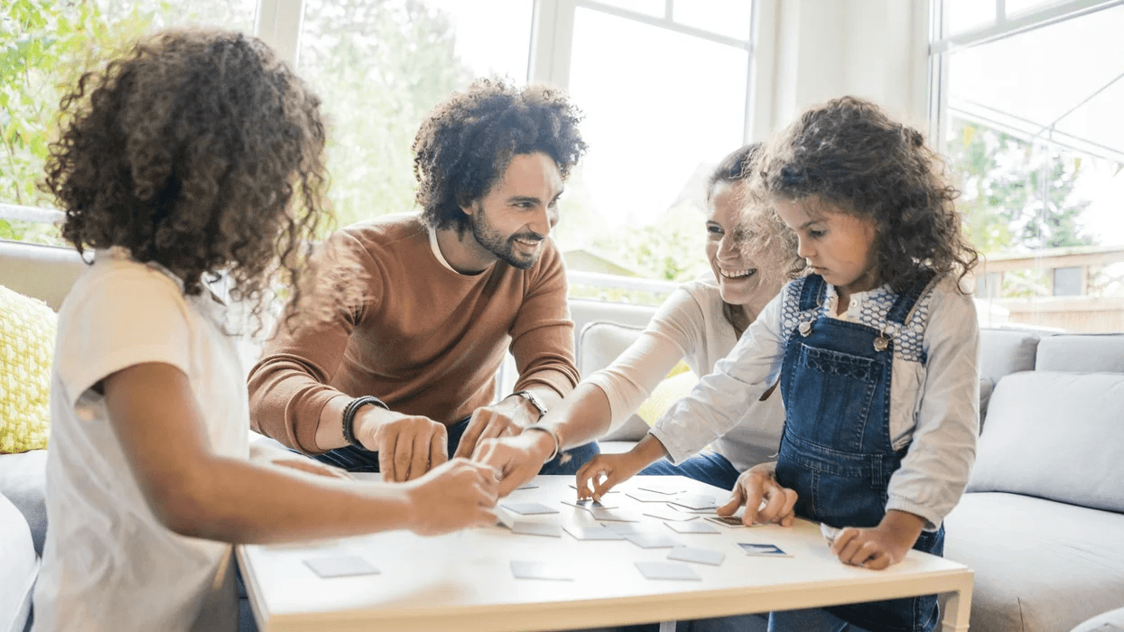 family playing a game around a table