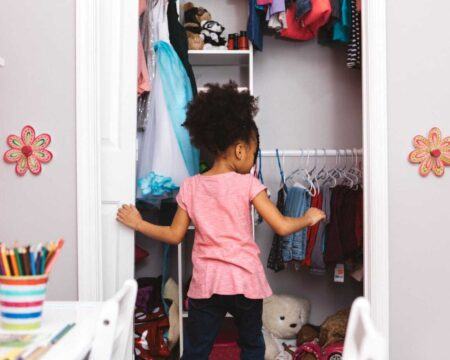 little girl opening her closet