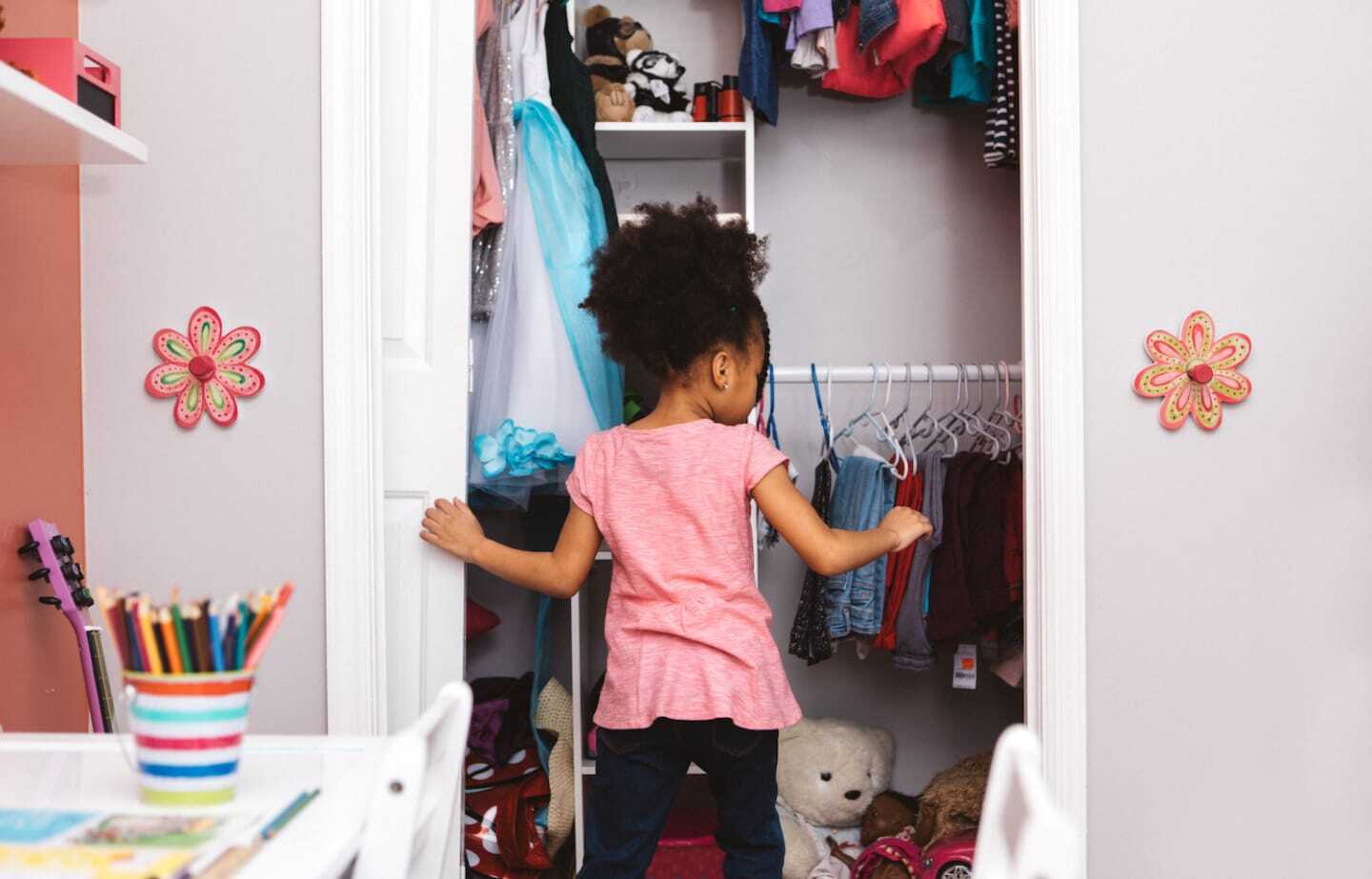 little girl opening her closet