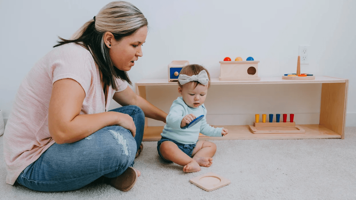 mom using montessori baby principles to play with her child at home