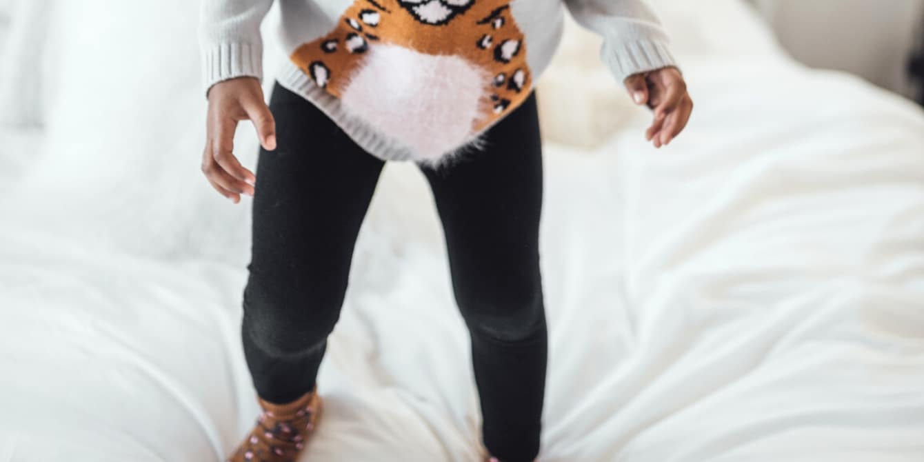 little-girl-jumping-on-the-bed