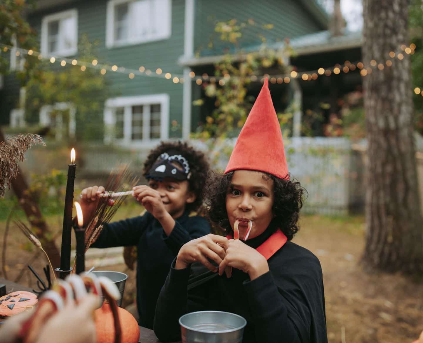 little kids eating halloween candy at a picnic table - halloween outdoor decorations