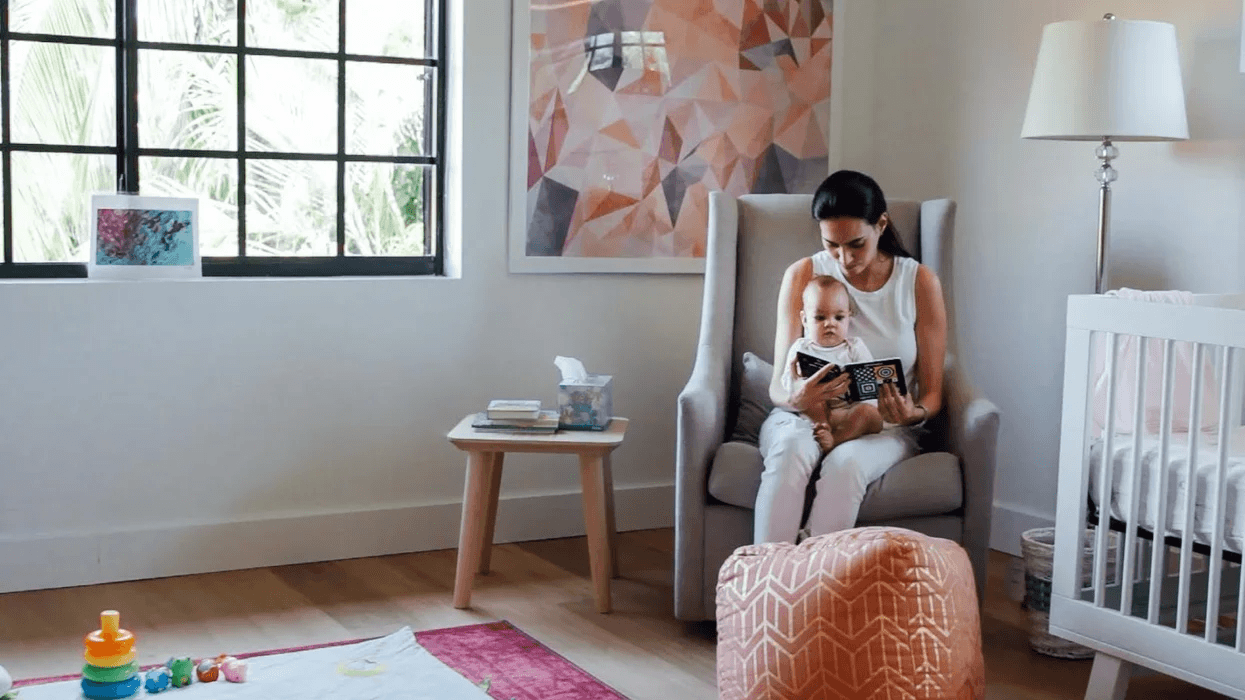 mom reading to baby in a nursery