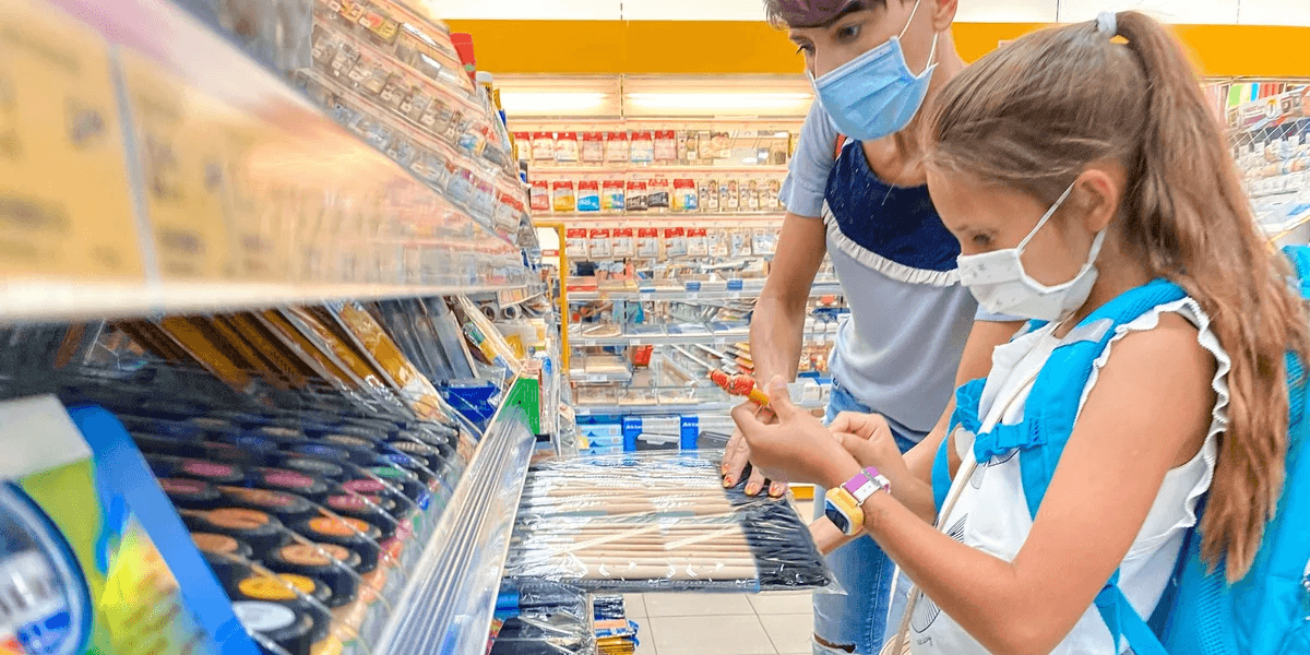 kids shopping for school supplies in masks