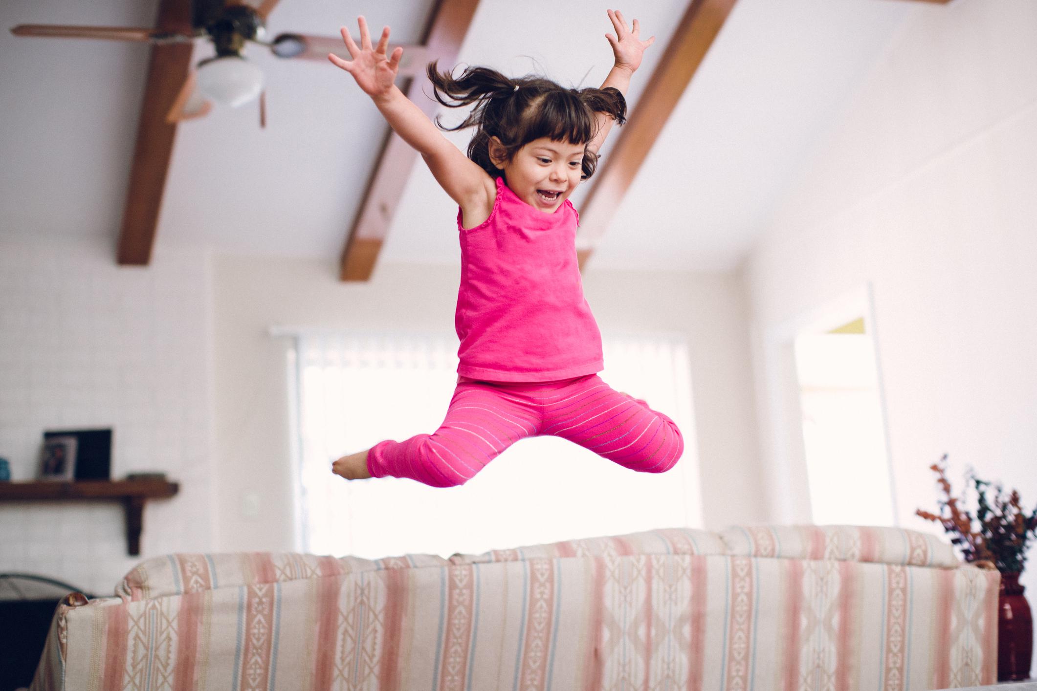 little girl jumping on the couch- how to parent a strong willed child