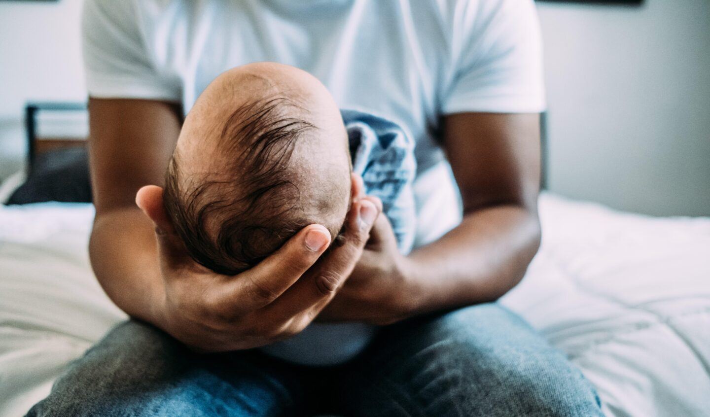 dad holding newborn baby