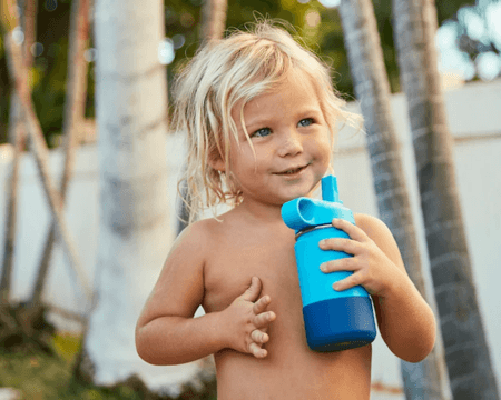 toddler with water bottle outside