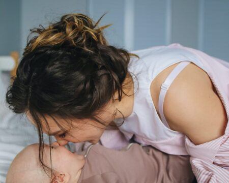 woman kissing baby