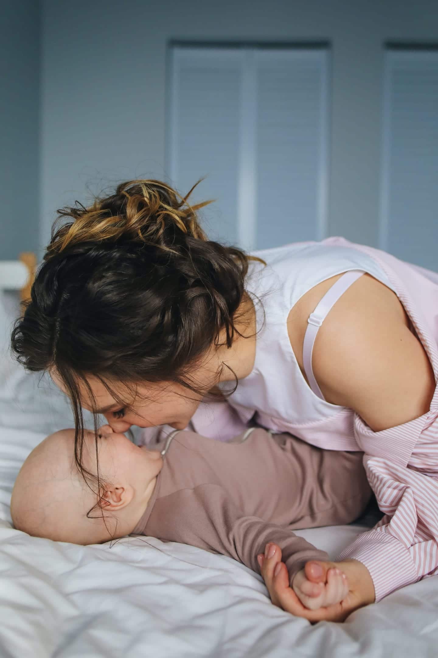 woman kissing baby