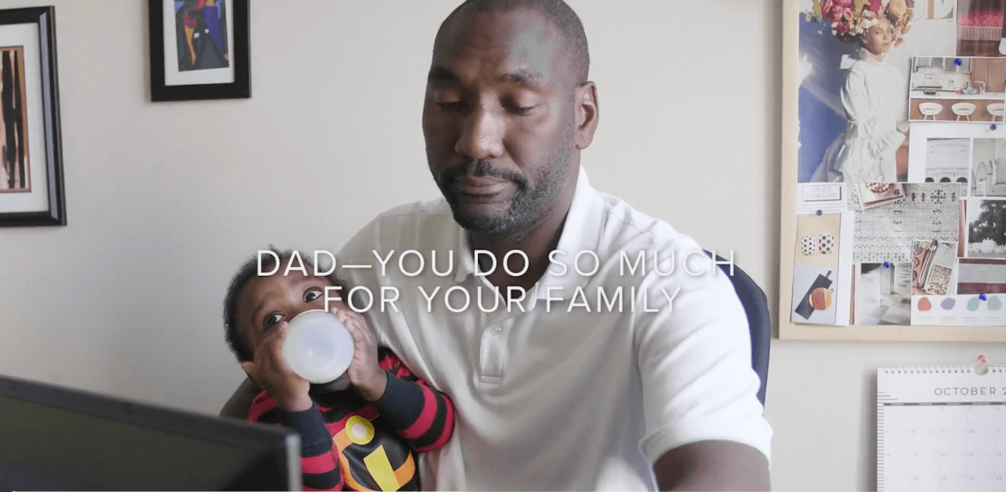 dad-holding-baby-while-working-video-screenshot