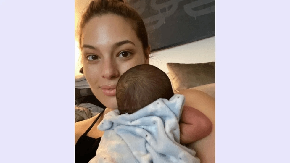 Ashley Graham holding her new baby