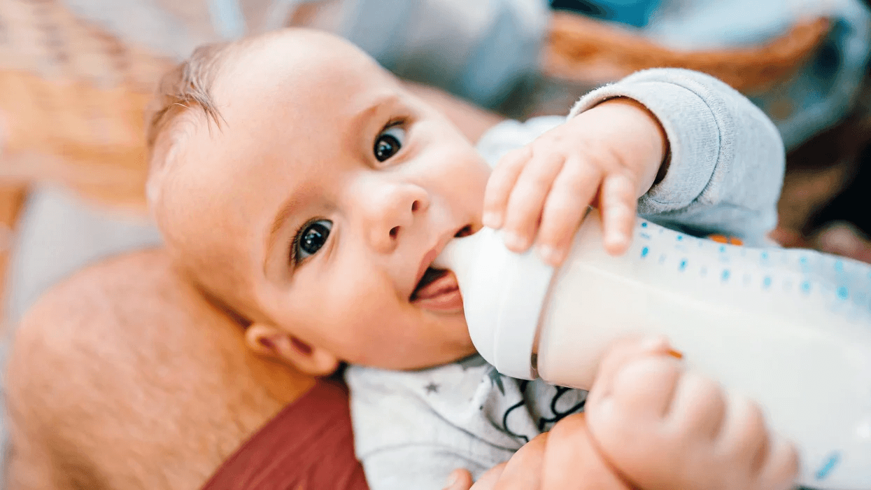 baby with bottle Motherly