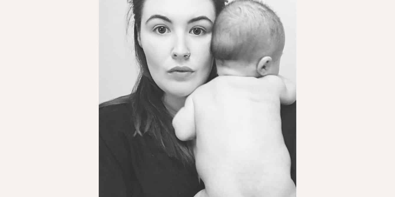 black and white photo of mom holding newborn baby - essay on experiencing postpartum anxiety