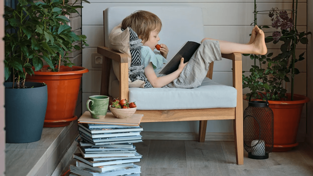 little-boy-reading-books-in-a-chair