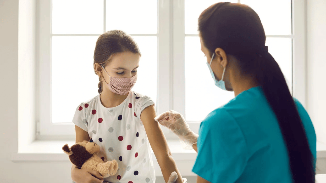 child getting vaccinated in doctors office