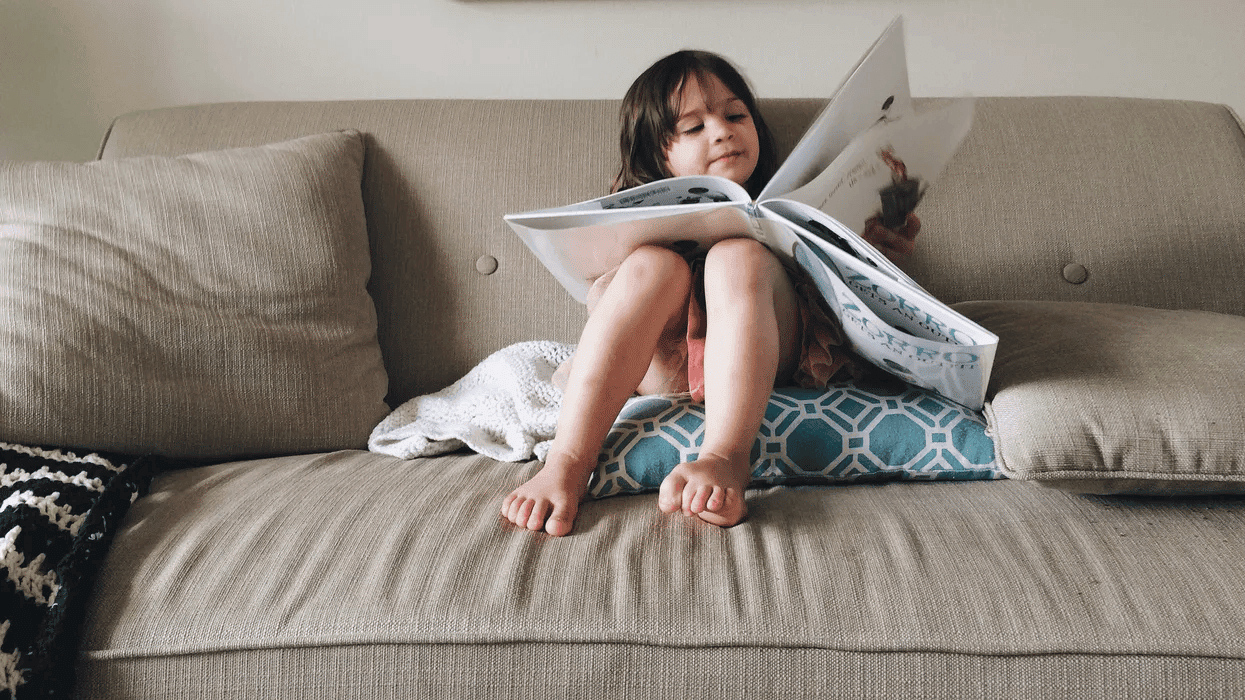 child reading a book- reading the same books to your child